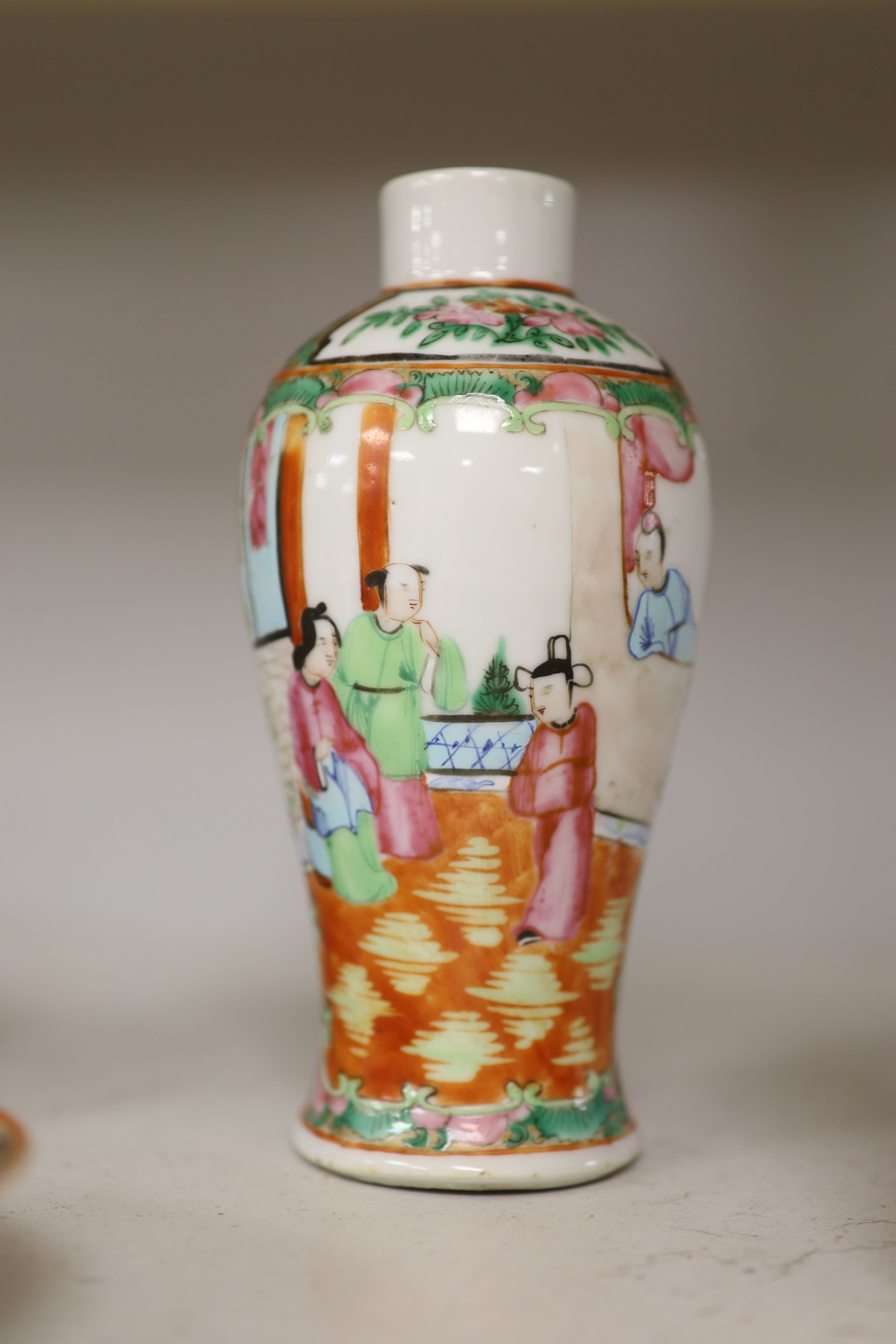 A Chinese famille rose box and cover, two vases, a sugar bowl and cover and a saucer, late 19th/early 20th century, tallest 19cm